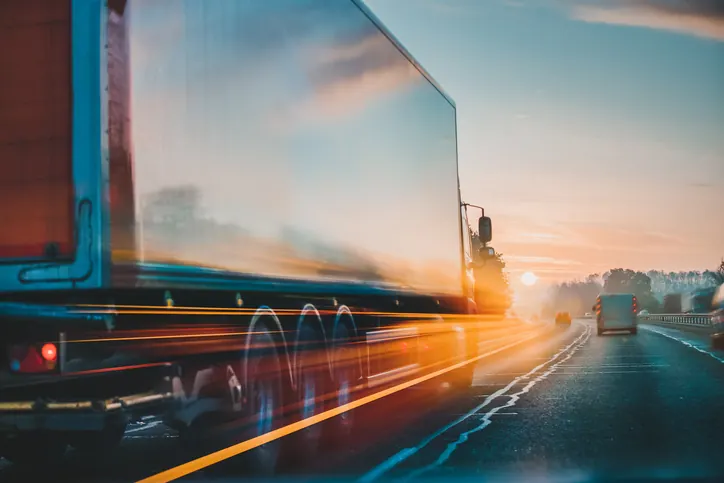Semi truck moving at highway speed at sunset — Bledsoe Truck & Trailer Repair offers fast turnaround and 24/7 road service so your truck spends less time off the road.